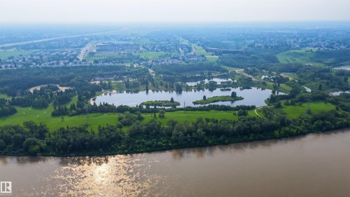 Expansive aerial perspective showcasing a significant body of water, multiple lakes, and abundant green spaces - 15 450 Hyndman Crescent, Edmonton, AB 