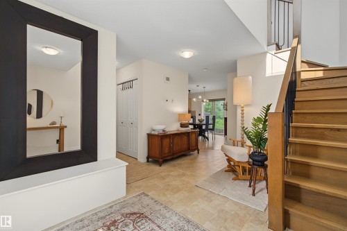 Hardwood staircase with black metal balusters and a wood handrail - 15 450 Hyndman Crescent, Edmonton, AB 