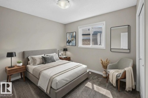 Carpeted bedroom featuring a double-paned window, neutral wall tones, a ceiling-mounted light fixture, and white trim - 2460 15 Avenue, Edmonton, AB 