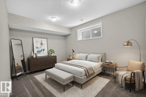 Carpeted room featuring a window with horizontal blinds, light gray walls, and a dropped ceiling with flush-mount lighting - 2460 15 Avenue, Edmonton, AB 