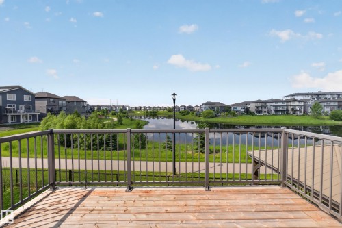 Exterior deck featuring wood-finish flooring and metal railings - 2460 15 Avenue, Edmonton, AB 