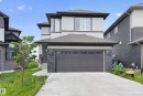 Contemporary two-story residence featuring a two-car garage, concrete driveway, and stone accents - 2460 15 Avenue, Edmonton, AB 