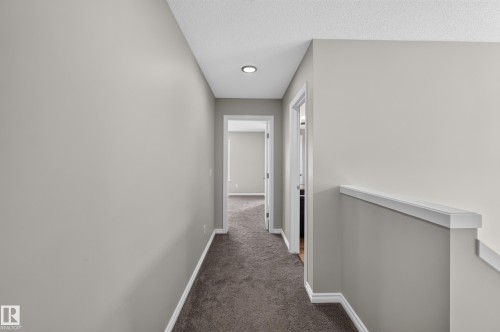 Hallway featuring neutral wall paint, recessed lighting, and carpeted flooring - 2460 15 Avenue, Edmonton, AB 