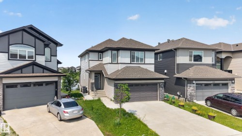 Contemporary residence featuring a two-story design, an attached two-car garage, and a concrete driveway - 2460 15 Avenue, Edmonton, AB 