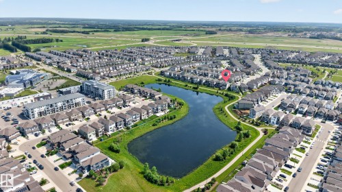 Residential neighborhood with a central pond feature, surrounded by green spaces and walking paths - 2460 15 Avenue, Edmonton, AB 