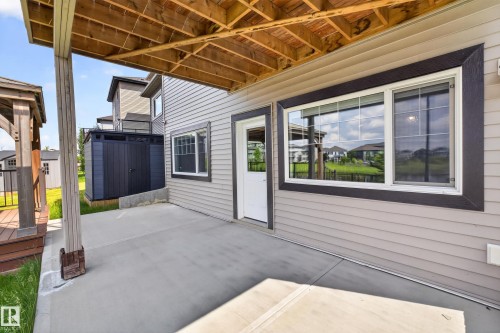 Covered concrete patio with exposed wood ceiling joists - 2460 15 Avenue, Edmonton, AB 