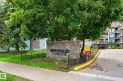 Stone-clad entrance monument featuring property signage - 