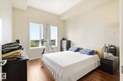 Bedroom featuring wood-finish flooring, a double window with a light-colored frame, cream-painted walls, and a light-colored ceiling - 