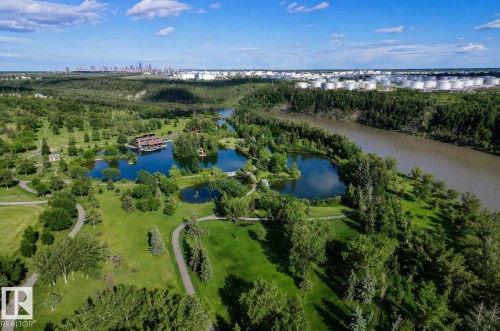 Expansive parkland featuring multiple ponds, mature trees, and winding paved pathways - 401 2908 116A Avenue, Edmonton, AB 