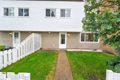 Two-story townhome featuring white horizontal siding and a complementary tan lower facade - 401 2908 116A Avenue, Edmonton, AB 