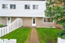 Two-story townhome featuring white horizontal siding and a complementary tan lower facade - 401 2908 116A Avenue, Edmonton, AB 