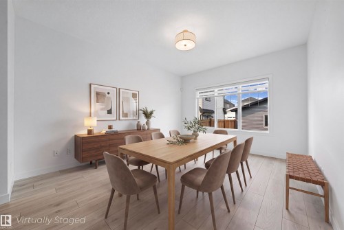 Bright dining area featuring light-toned wood-finish flooring - 2953 Coughlan Green Green, Edmonton, AB 