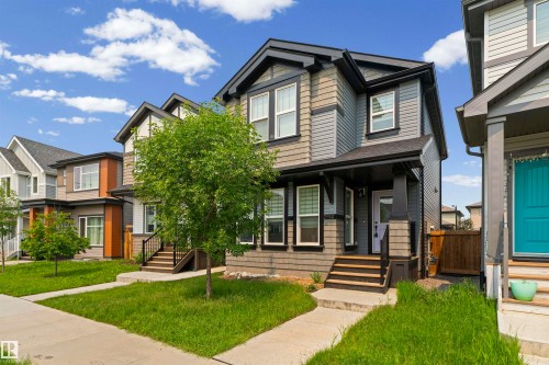 Contemporary two-story residence featuring multi-toned siding, dark trim accents, and a covered front entry - 2953 Coughlan Green Green, Edmonton, AB 