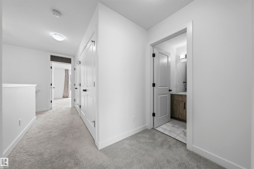 Hallway with gray carpeting, white walls, and white trim - 2953 Coughlan Green Green, Edmonton, AB 