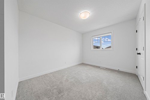 White walls featuring a single window and a flush-mount ceiling light - 2953 Coughlan Green Green, Edmonton, AB 