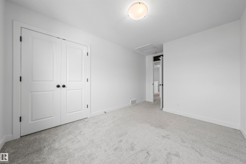 Interior room featuring light gray carpeting, white walls, and white baseboards - 2953 Coughlan Green Green, Edmonton, AB 