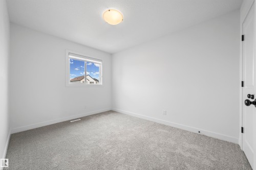 Bright room featuring light gray carpeting, white walls, and a single window with white trim - 2953 Coughlan Green Green, Edmonton, AB 