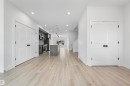 Open-concept interior featuring light wood-finish flooring throughout - 2953 Coughlan Green Green, Edmonton, AB 