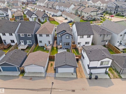 Contemporary residential streetscape featuring detached homes with asphalt shingle roofs - 2953 Coughlan Green Green, Edmonton, AB 