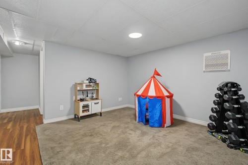 Spacious room featuring light gray walls, white trim, recessed lighting, and a drop ceiling - 3622 115 Avenue, Edmonton, AB 