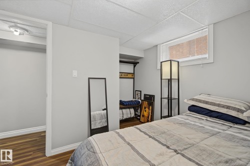 Room featuring light gray walls and wood-finish flooring - 3622 115 Avenue, Edmonton, AB 