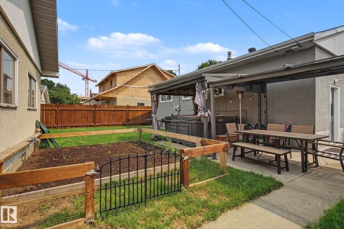 Expansive concrete patio area with a built-in covered structure - 3622 115 Avenue, Edmonton, AB 