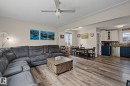 Open-concept living area featuring wood-finish flooring, a ceiling fan, and recessed lighting - 3622 115 Avenue, Edmonton, AB 
