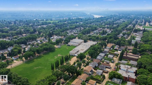 Aerial perspective showcasing an expansive residential area with abundant mature trees and a distant river - 3622 115 Avenue, Edmonton, AB 