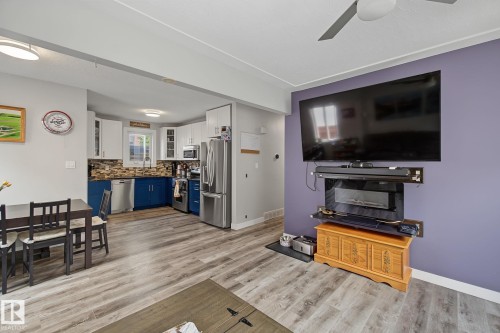 Open-concept living space featuring wood-finish flooring - 3622 115 Avenue, Edmonton, AB 