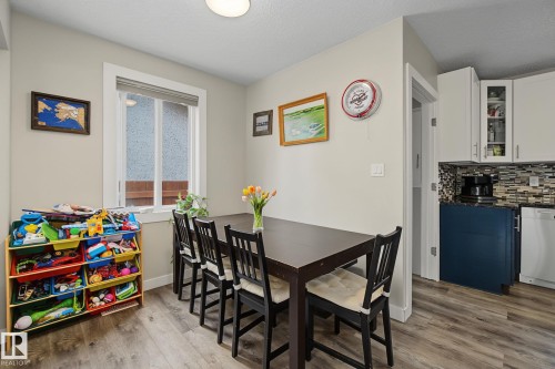 Dining area featuring wood-finish flooring and a white-trimmed window - 3622 115 Avenue, Edmonton, AB 