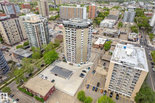 Central high-rise building with multiple balconies, surrounded by a dense urban environment featuring other multi-story buildings and street infrastructure - 503 10045 117 Street, Edmonton, AB 