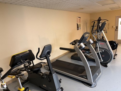 Dedicated fitness area featuring a variety of exercise equipment - 503 10045 117 Street, Edmonton, AB 