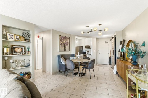Open-concept living space featuring tile flooring and neutral wall tones - 503 10045 117 Street, Edmonton, AB 