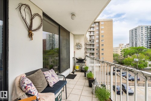 Spacious balcony featuring off-white tiled flooring and a white railing - 503 10045 117 Street, Edmonton, AB 