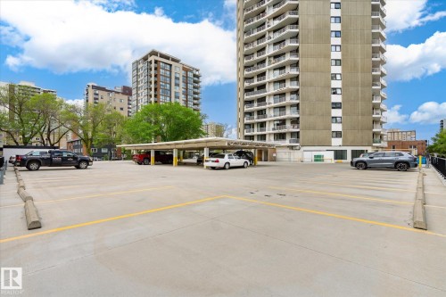 Expansive exterior parking area featuring marked spaces and concrete construction - 503 10045 117 Street, Edmonton, AB 