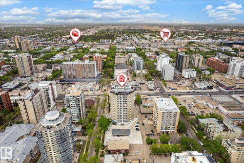 Aerial perspective showcasing a dense urban environment with a variety of multi-story buildings and verdant tree-lined streets - 503 10045 117 Street, Edmonton, AB 