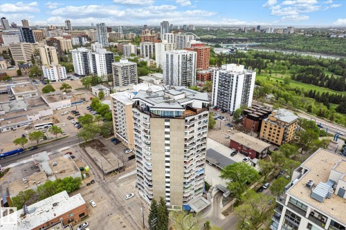 High-rise building with a distinctive pentagonal roofline, featuring individual balconies and a multi-level base with integrated parking - 503 10045 117 Street, Edmonton, AB 
