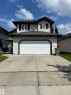 Two-story residential property featuring light-colored horizontal siding and a dark shingle roof - 17 Willowby Close, Stony Plain, AB 