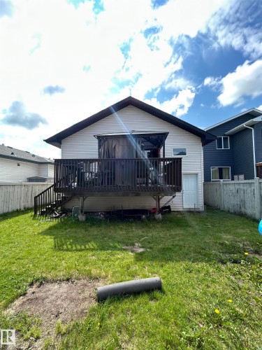 Rear exterior featuring a spacious wooden deck with railings and steps - 17 Willowby Close, Stony Plain, AB 