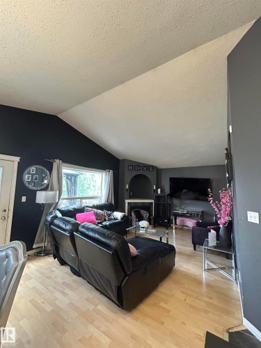 Vaulted ceiling living area featuring light wood-finish flooring - 17 Willowby Close, Stony Plain, AB 