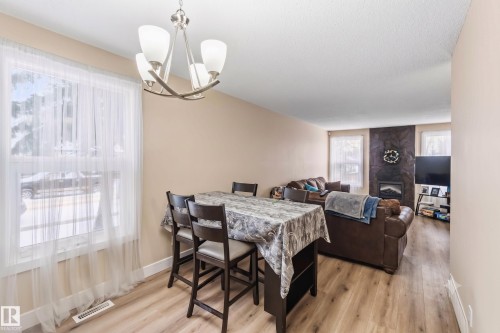 Open-concept dining and living areas featuring wood-finish flooring - 17118 108 Street, Edmonton, AB 