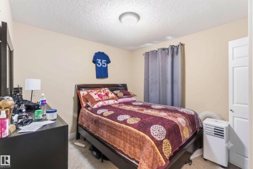 Bedroom featuring carpeted flooring and neutral wall tones - 17118 108 Street, Edmonton, AB 