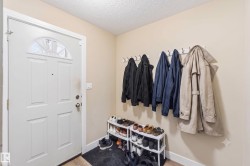 Entryway featuring a paneled door with an arched transom window - 