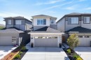 Modern multi-level home featuring light gray siding and stone facade accents - 20907 131 Avenue, Edmonton, AB 