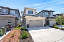 Modern exterior featuring light-colored stone accents, horizontal siding, and a prominent front entry - 20907 131 Avenue, Edmonton, AB 