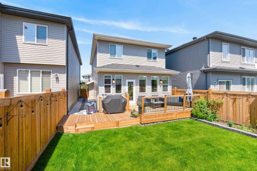 Expansive backyard featuring a lush lawn and a multi-level wood deck - 20907 131 Avenue, Edmonton, AB 
