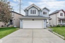 Light blue siding exterior with white trim and a dark shingled roof - 3449 28 Street, Edmonton, AB 