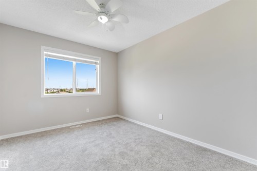 Neutral tone walls with a ceiling fan light fixture - 3449 28 Street, Edmonton, AB 