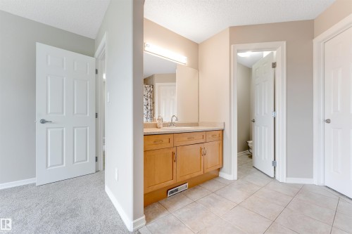 Light wood-finish vanity with a light-colored countertop and integrated sink - 3449 28 Street, Edmonton, AB 