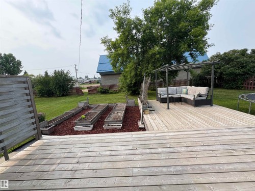 Spacious wood deck and raised gardens. - 4806 50 Avenue, Elk Point, AB 